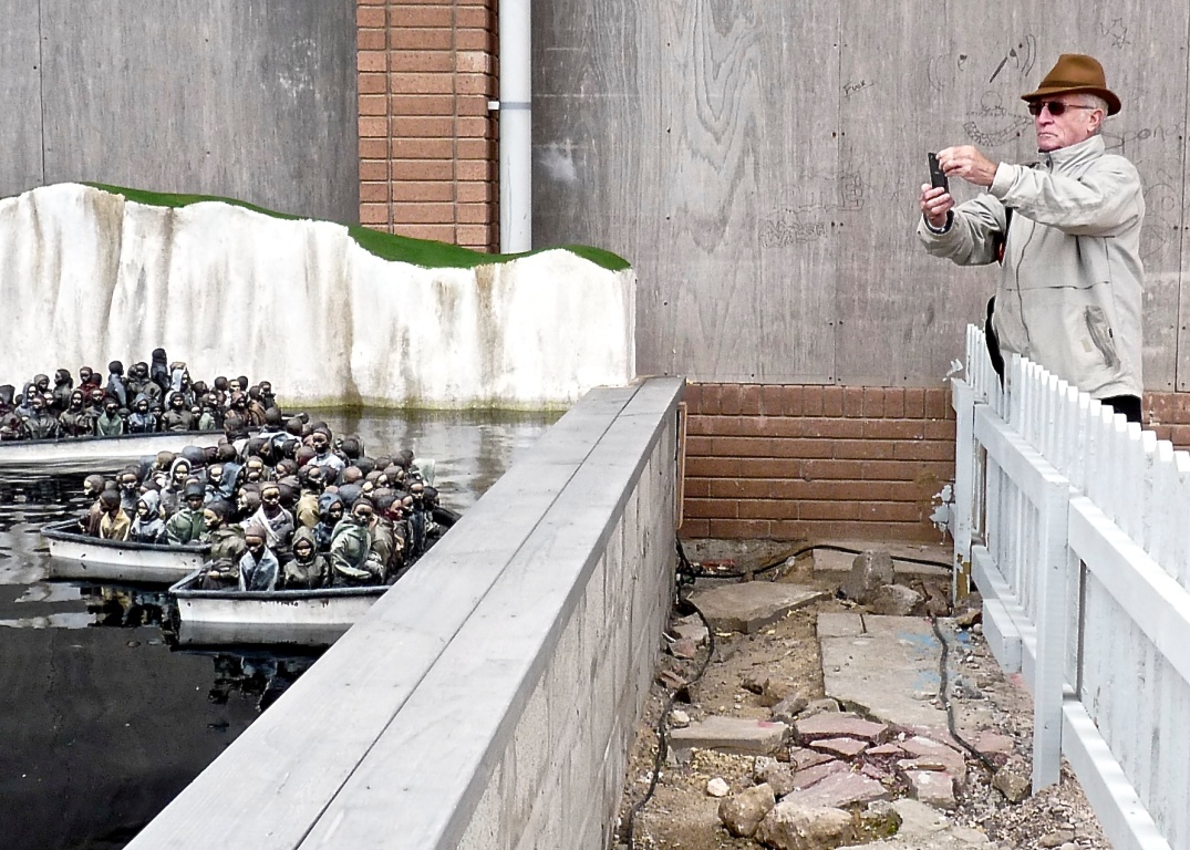 Photographing 'The Migrant Boat Pond' by Banksy 